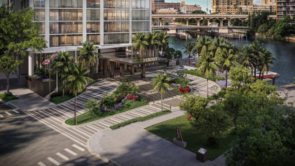 A view of the landscaped courtyard and waterfront walkway at Pendry Tampa