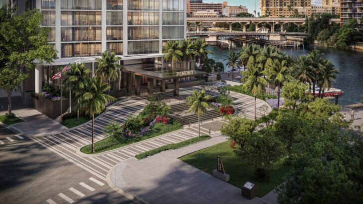 A view of the landscaped courtyard and waterfront walkway at Pendry Tampa