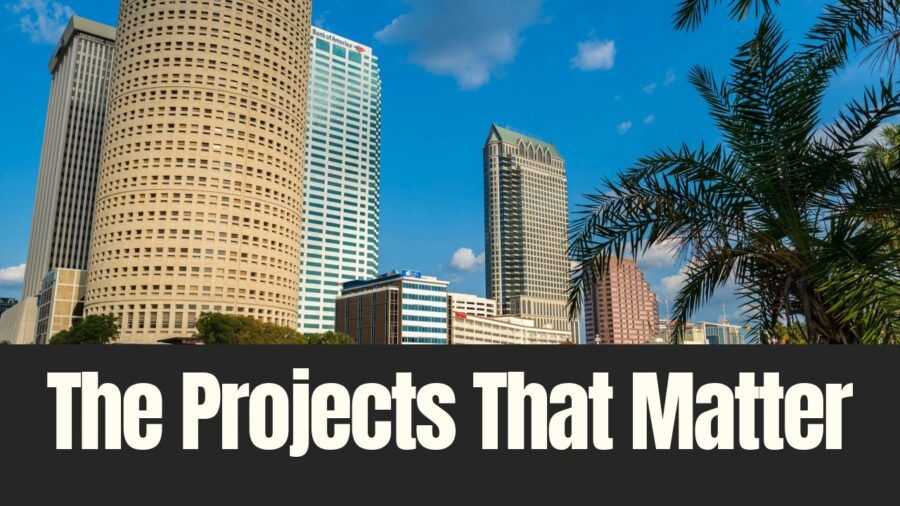 Downtown Tampa skyline with office towers and palm trees under a blue sky, illustrating major real estate projects shaping Tampa Bay.