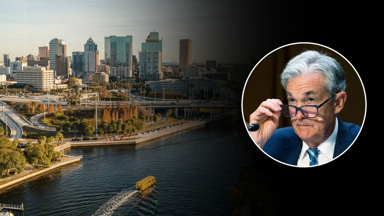 A view of downtown Tampa along the river with an inset photo of Federal Reserve Chair Jerome Powell adjusting his glasses.