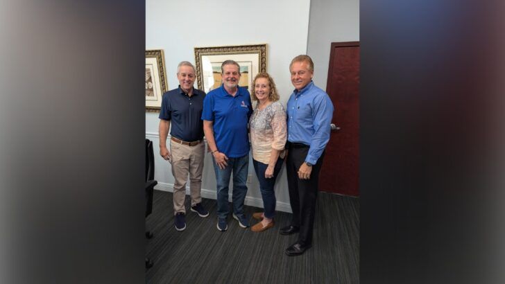 Owners and buyer pose together at the closing of Precise Technologies Inc. in Largo, Florida.