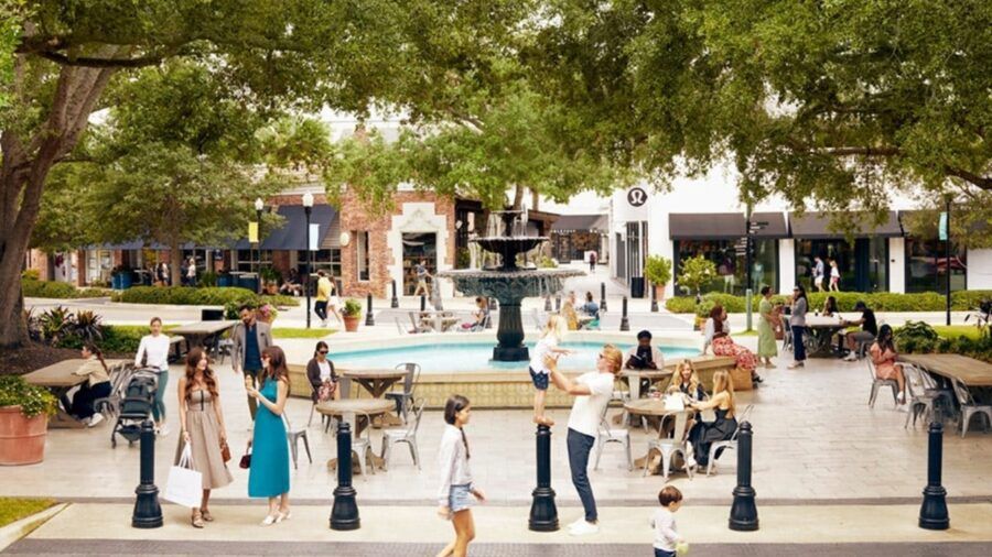 Shoppers and diners gather around the central fountain at Hyde Park Village in Tampa