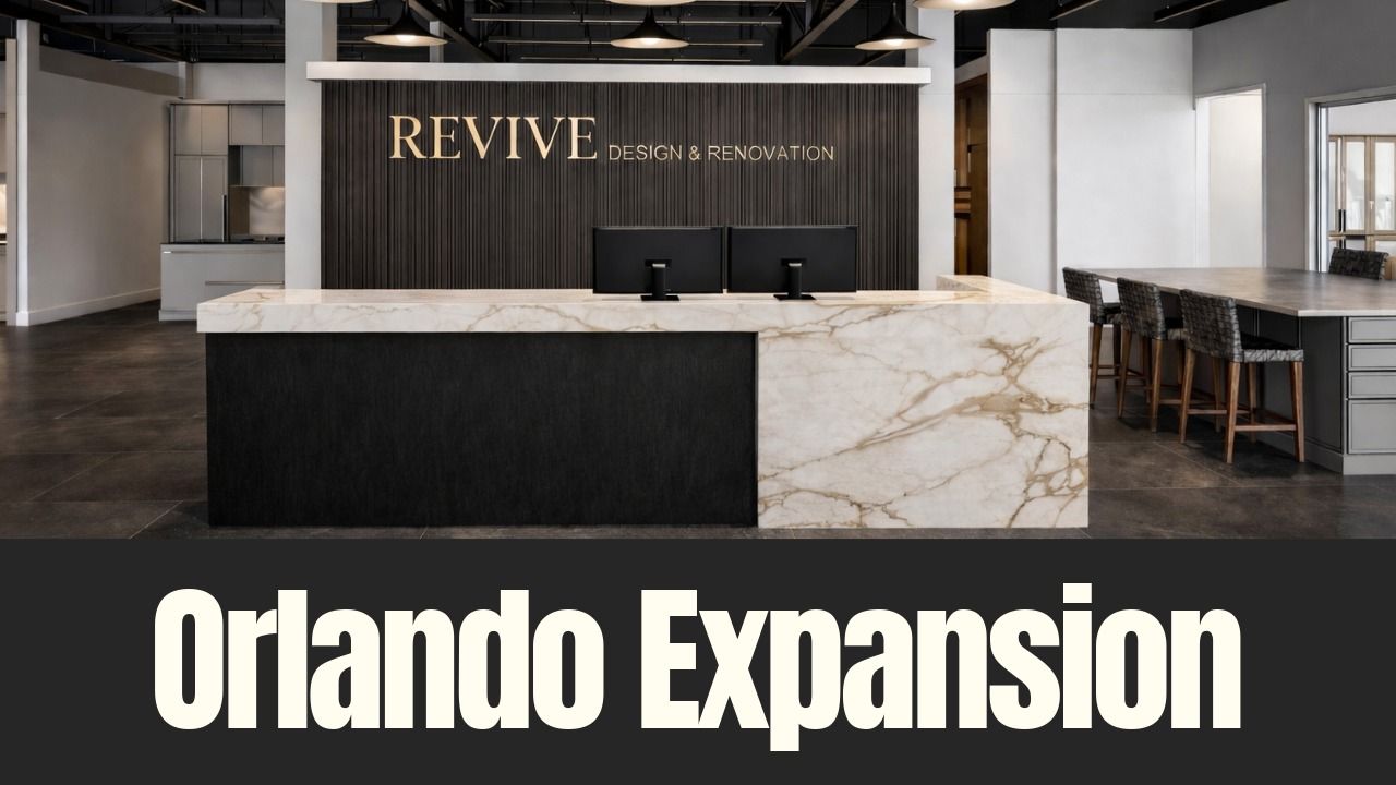 Revive Design and Renovation’s new Orlando showroom interior featuring a marble reception desk and design workspace