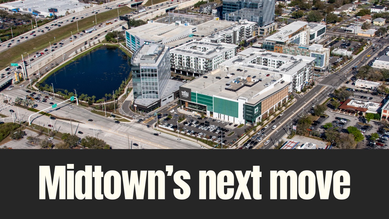 Aerial view of Midtown Tampa showing the retail core anchored by Whole Foods Market, surrounded by offices, apartments and major roadways in Tampa.