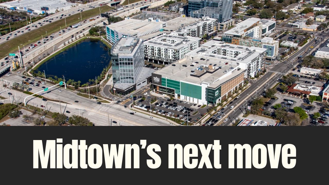 Aerial view of Midtown Tampa showing the retail core anchored by Whole Foods Market, surrounded by offices, apartments and major roadways in Tampa.