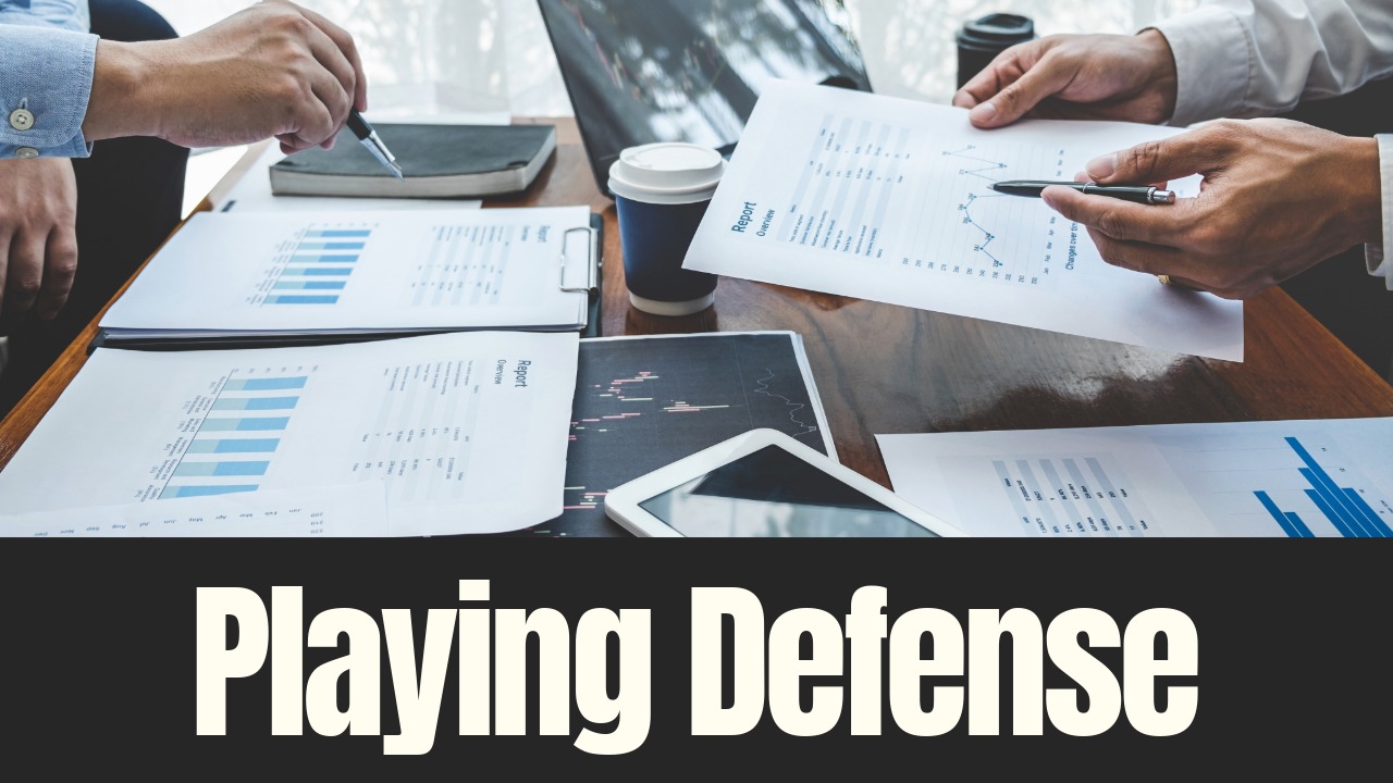Investors review financial reports and market data while discussing risk and asset allocation during economic uncertainty.