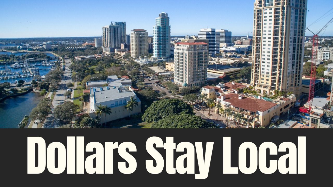 Aerial view of downtown St. Petersburg showing waterfront, high-rise buildings and marina, highlighting how tourism dollars support local infrastructure and growth.