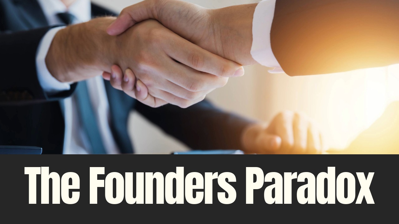 Two business professionals shaking hands across a desk, symbolizing a high-stakes business decision and the moment of transition during a company sale.