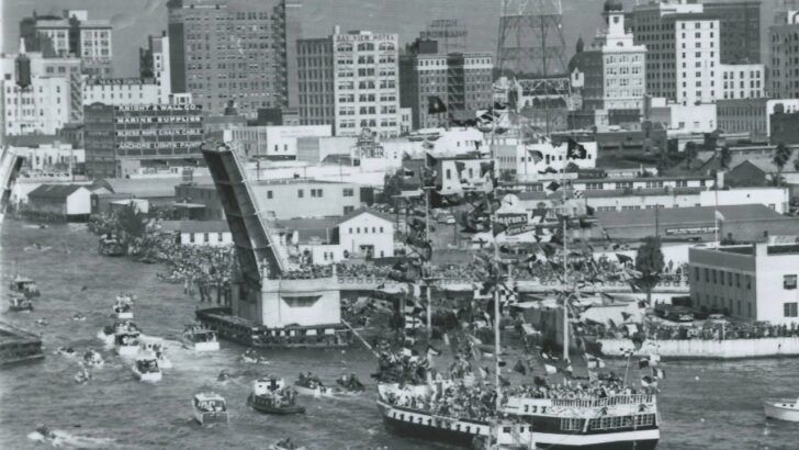 The José Gasparilla pirate ship leads the annual Gasparilla invasion through the Hillsborough River as boats crowd the water near downtown Tampa.