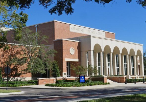 esuit High School campus building in Tampa with brick exterior and arched colonnade.
