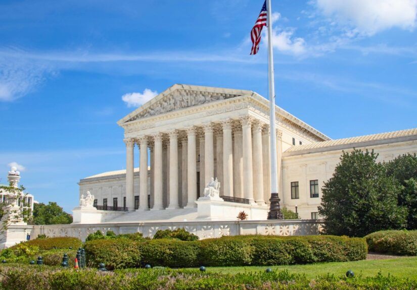 U.S. Supreme Court building in Washington, D.C., with American flag flying above the columns