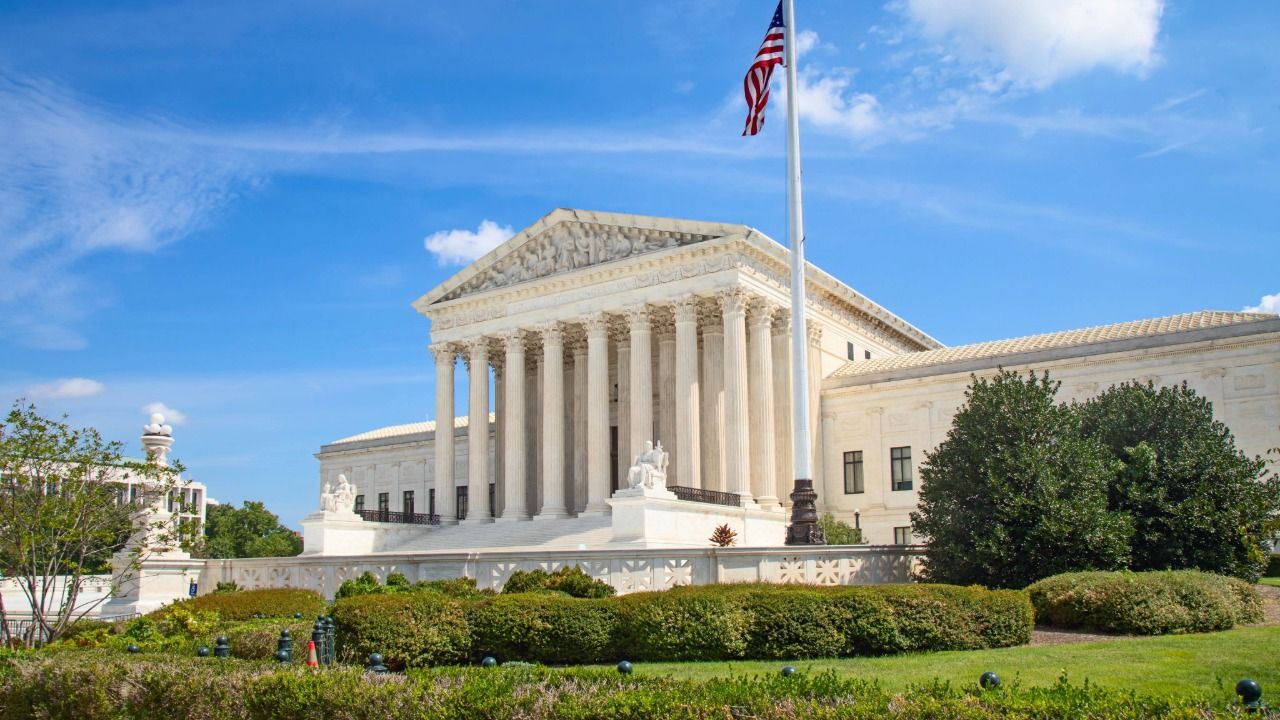 U.S. Supreme Court building in Washington, D.C., with American flag flying above the columns