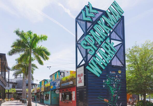 Sparkman Wharf sign towering above waterfront retail and dining containers in downtown Tampa.