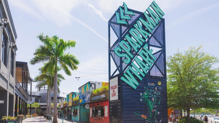 Sparkman Wharf sign towering above waterfront retail and dining containers in downtown Tampa.