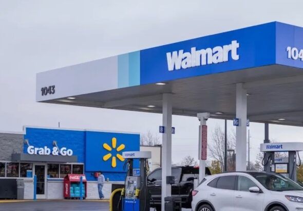 Walmart fuel station with multiple gas pumps and convenience store under blue Walmart canopy