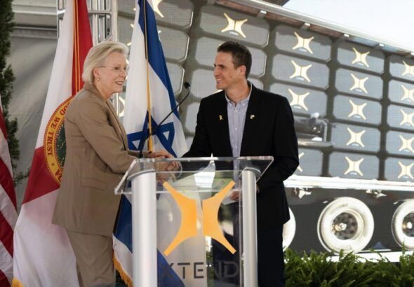 Tampa Mayor Jane Castor shakes hands with XTEND CEO Aviv Shapira at a Tampa headquarters announcement event