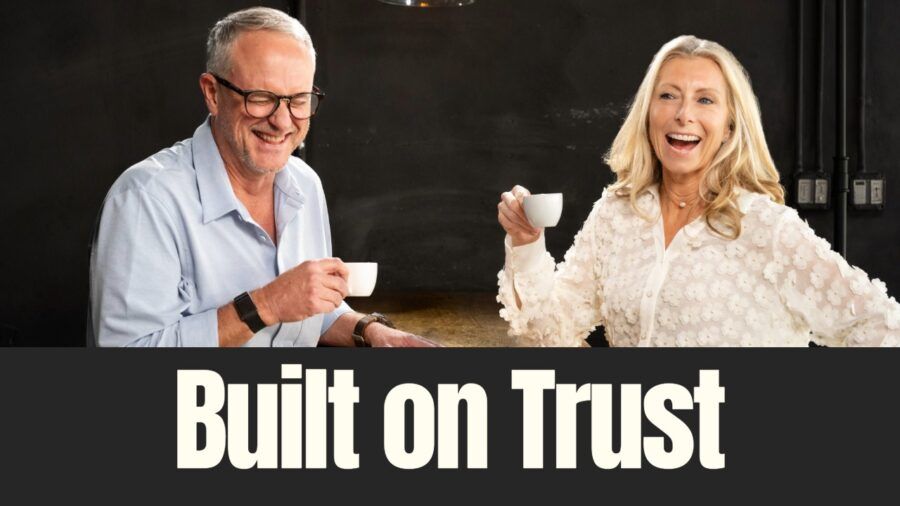 Dave and Susan Ward laugh together while holding coffee cups inside a Buddy Brew Coffee space. Photo courtesy of Evan Smith.