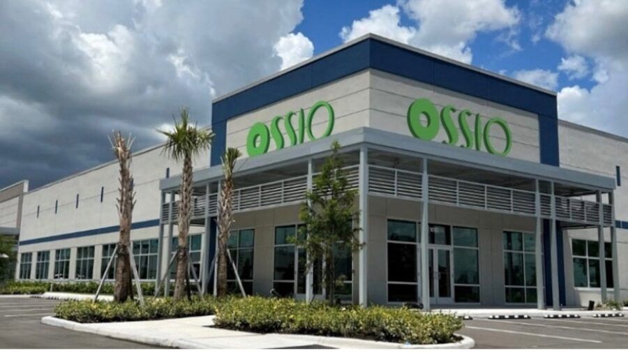 Employees, business leaders and officials stand outside a new U.S. headquarters building during a ribbon-cutting event in Palmetto, Florida.