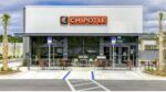 Exterior of a Chipotle Mexican Grill restaurant with patio seating in Lutz, Florida.
