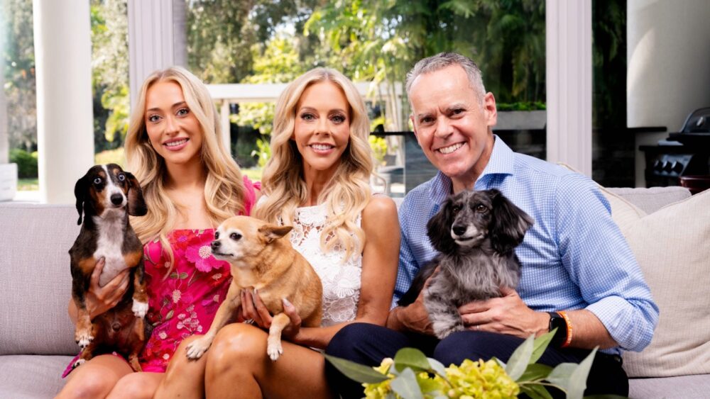 Liz Folce and Robert DeBaker sit with their daughter and three dogs in their Florida home.
