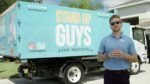 Casey Walsh stands in front of a Stand Up Guys Junk Removal truck in Tampa.