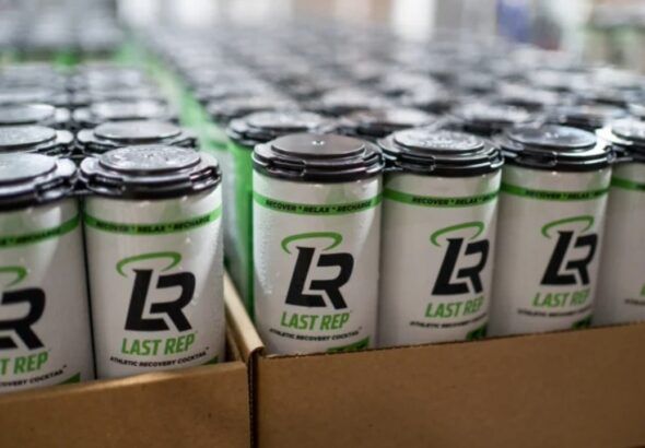 Cans of Last Rep THC recovery drink on a production line during an early manufacturing run.