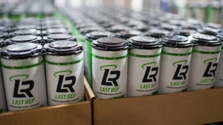 Cans of Last Rep THC recovery drink on a production line during an early manufacturing run.