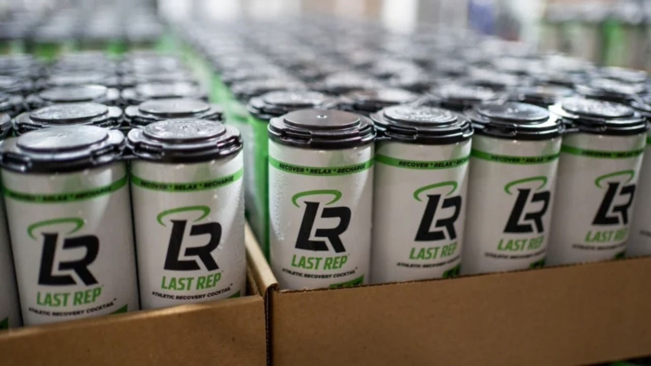 Cans of Last Rep THC recovery drink on a production line during an early manufacturing run.