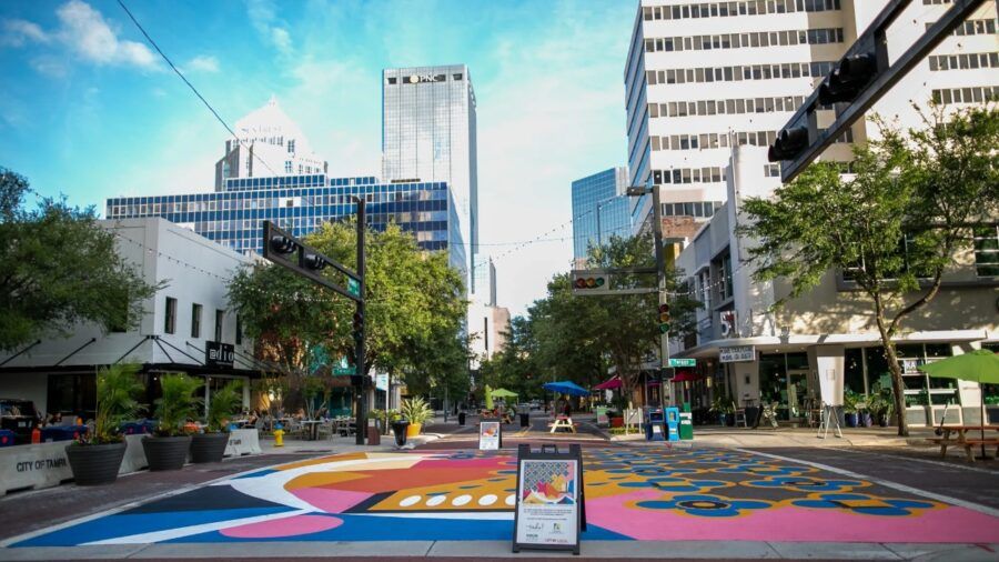 Franklin Street pedestrian zone in downtown Tampa with outdoor dining, street art and nearby office towers.