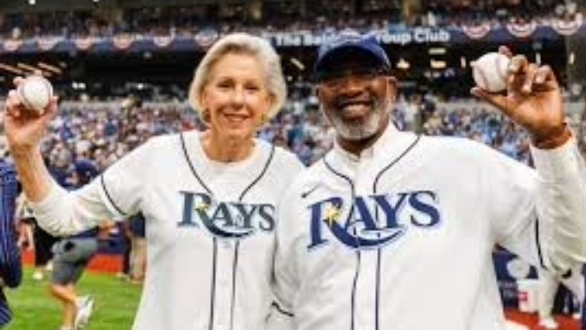 Tampa Mayor Jane Castor and St. Petersburg Mayor Ken Welch hold baseballs on the field at a Tampa Bay Rays game