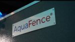 Close-up of AquaFence logo on an engineered flood barrier panel