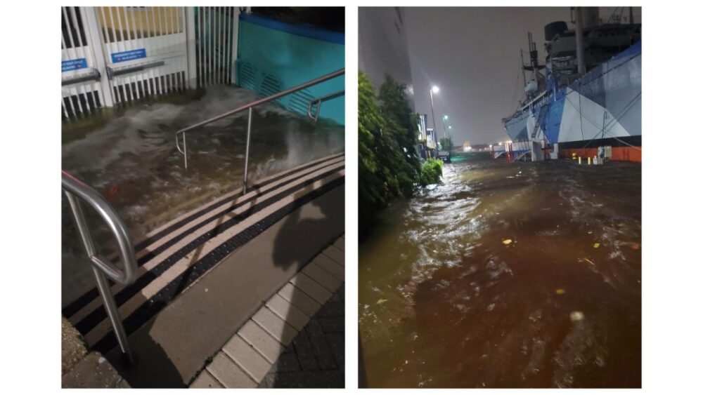 Floodwaters rise outside The Florida Aquarium during a storm, covering steps and nearby waterfront areas