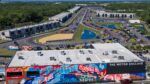 Aerial view of The Motor Enclave in Tampa with racetrack, garages, and event crowds
