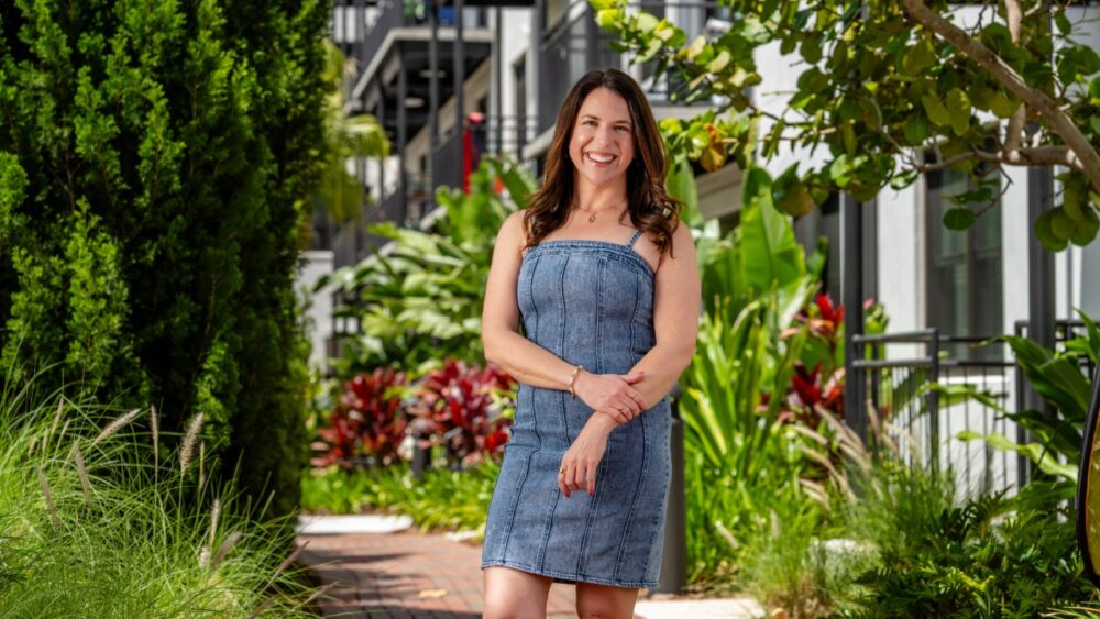 Gina Curry, CEO of NextPath Career Partners, stands in her Tampa office