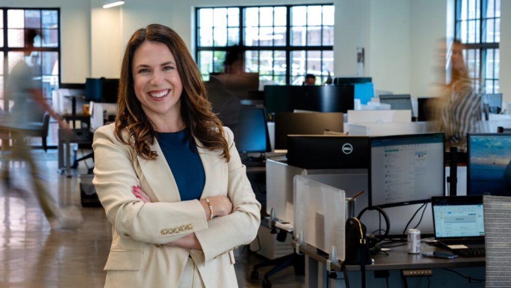 Gina Curry, CEO of NextPath Career Partners, stands in her Tampa office