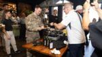 Chef Robert Irvine serves a meal to a U.S. service member during a Tampa Bay Wine & Food Festival event.