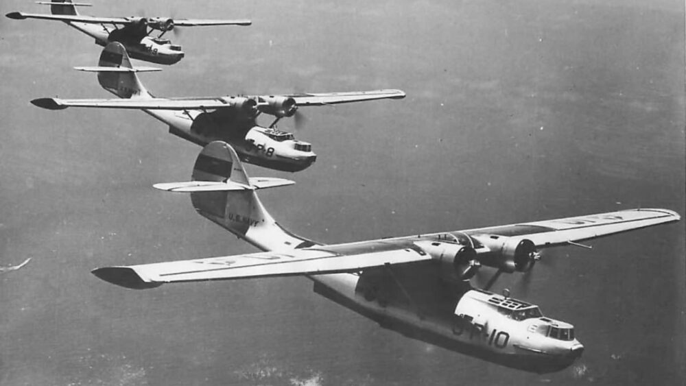 World War II-era PBY Catalina flying boats in formation over open water