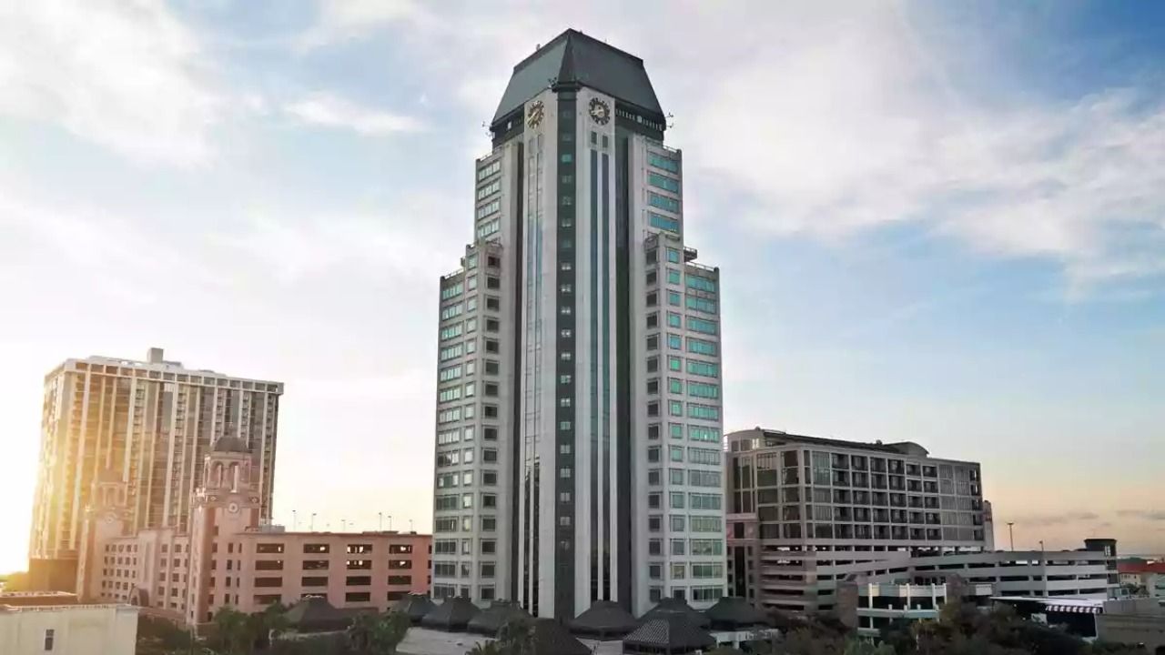 200 Central Avenue office tower rises above downtown St. Petersburg skyline at sunset.