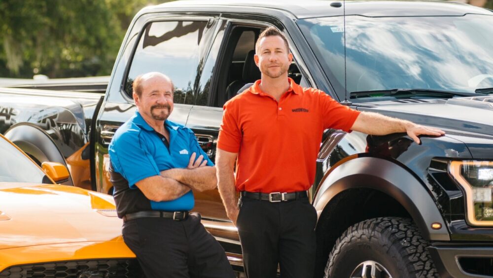 Benny Robles Jr. and Benny Robles Sr. stand with Ford vehicles at Bartow Ford in Bartow.