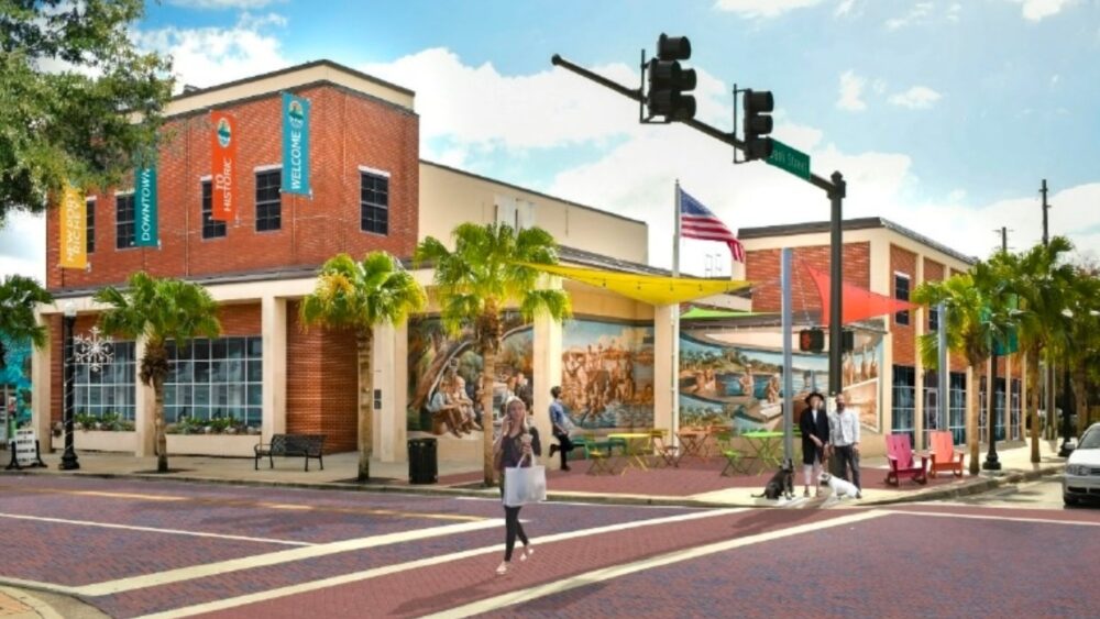 Concept rendering showing a potential redevelopment of the former health department building with storefront windows and outdoor seating.