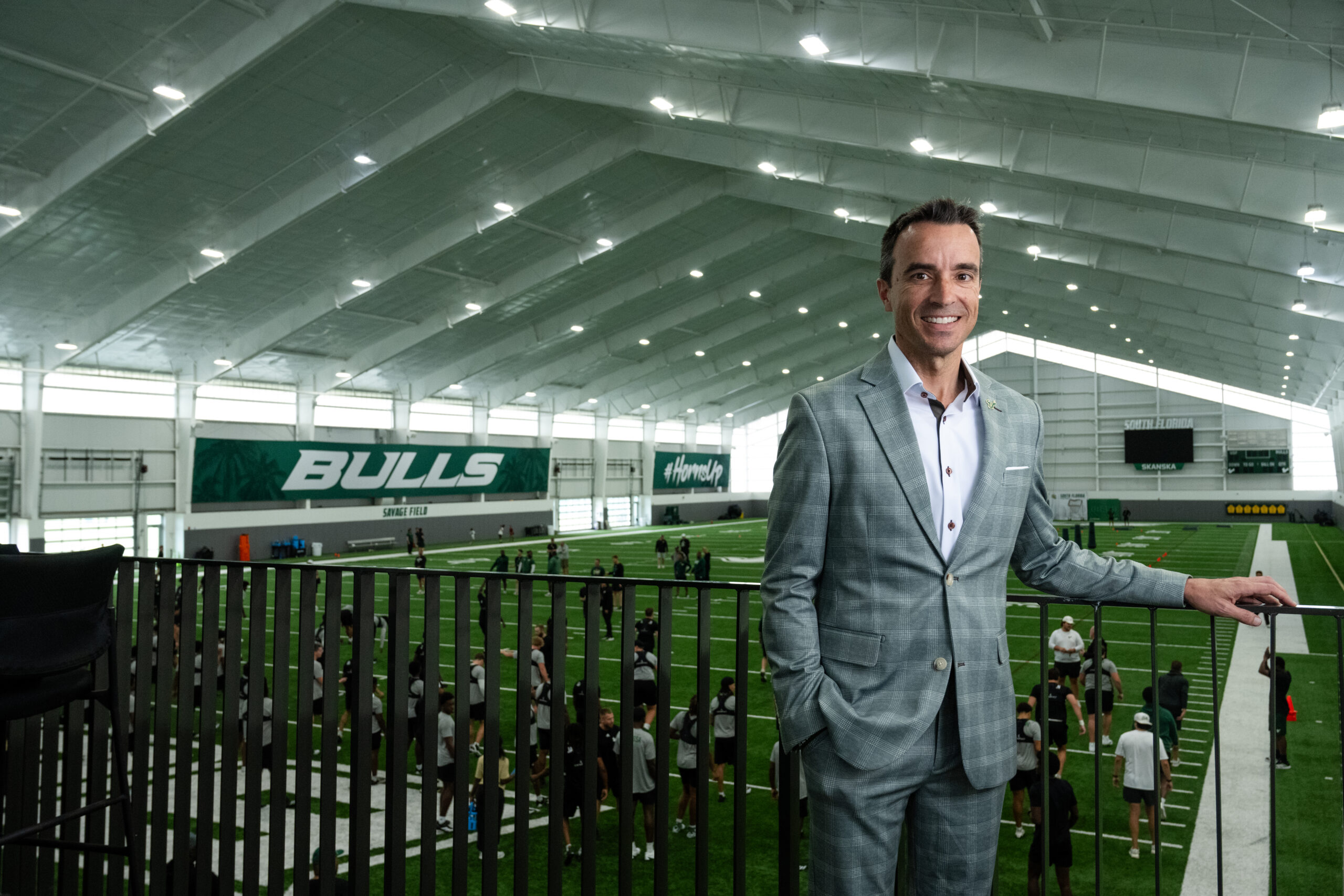 Rob Higgins overlooks practice inside USF’s indoor football facility