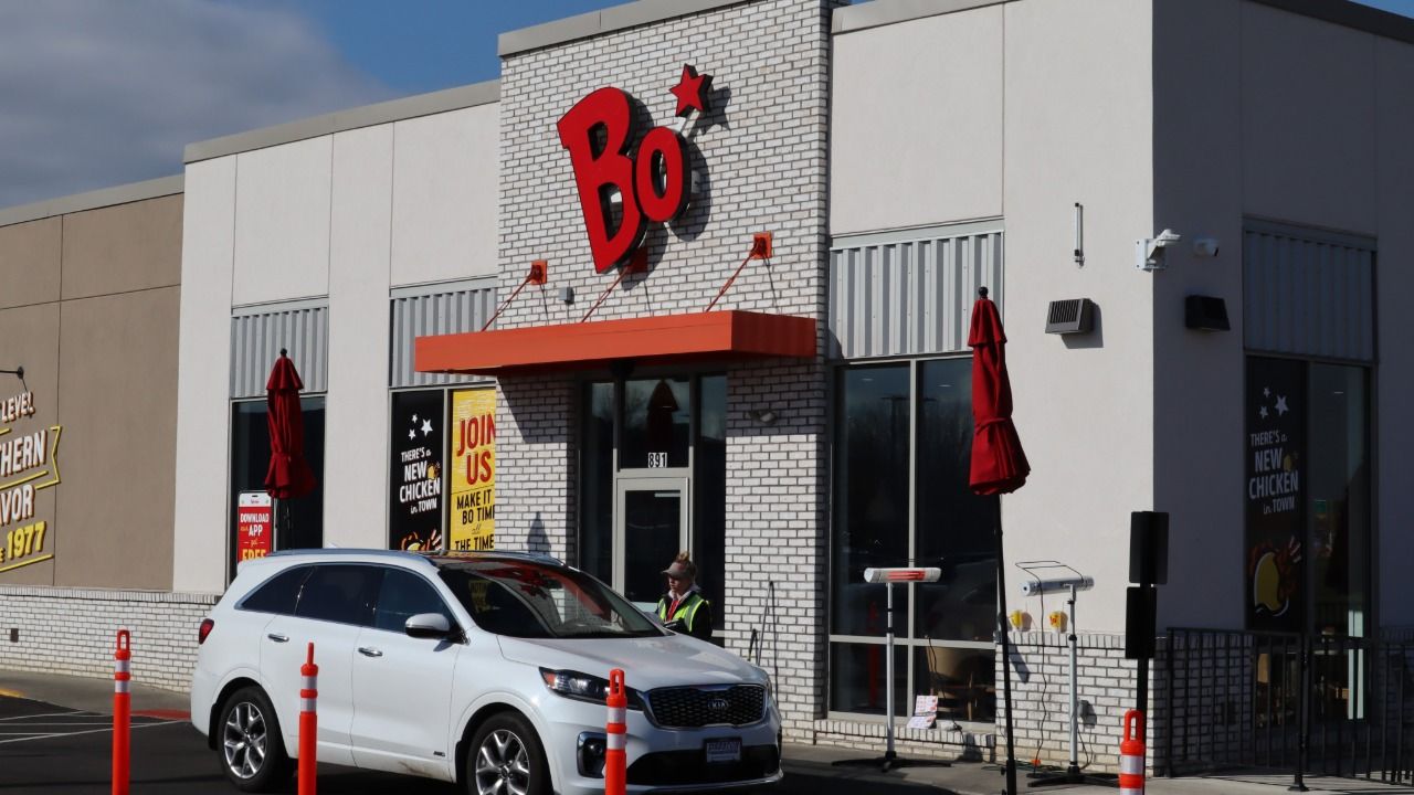 A Bojangles restaurant with a drive-thru customer.