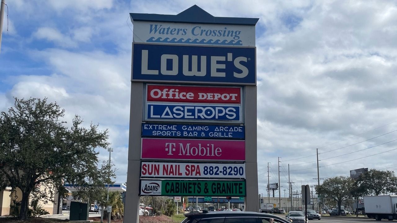 Waters Crossing sign on West Waters Avenue showing Lowe’s, Office Depot, LaserOps, T-Mobile and other tenants.