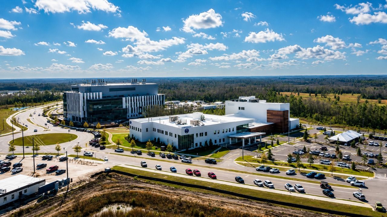 Aerial view of the Speros campus in Pasco County showing modern research and medical buildings surrounded by roads, parking areas and undeveloped land.