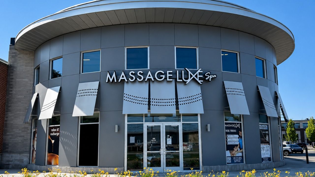 MassageLuXe spa storefront with exterior signage and landscaped entrance