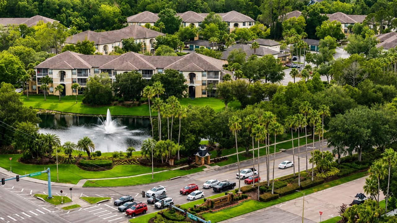 Aerial view of Mission Village in Tampa’s Palm River area, with residential buildings, a pond and surrounding roads.