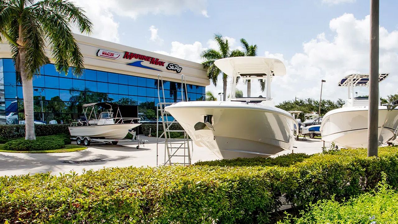 MarineMax dealership with boats on display outside its waterfront retail facility.