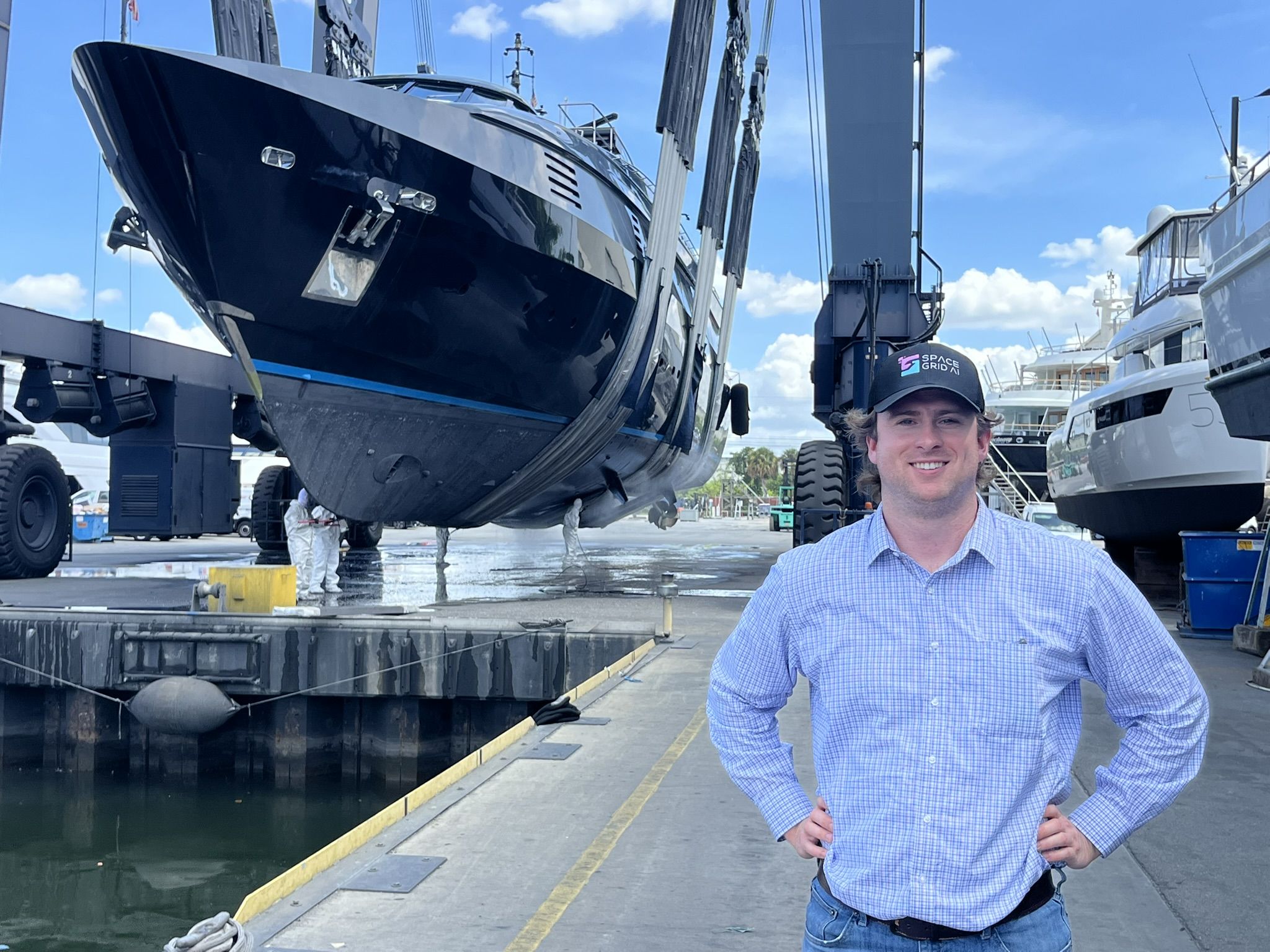 Space Grid AI founder Alex Hilger at a shipyard with a vessel being lifted