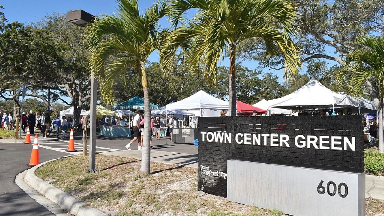 Town Center Green sign at 600 Bay Isles Road in Longboat Key during an outdoor community event.