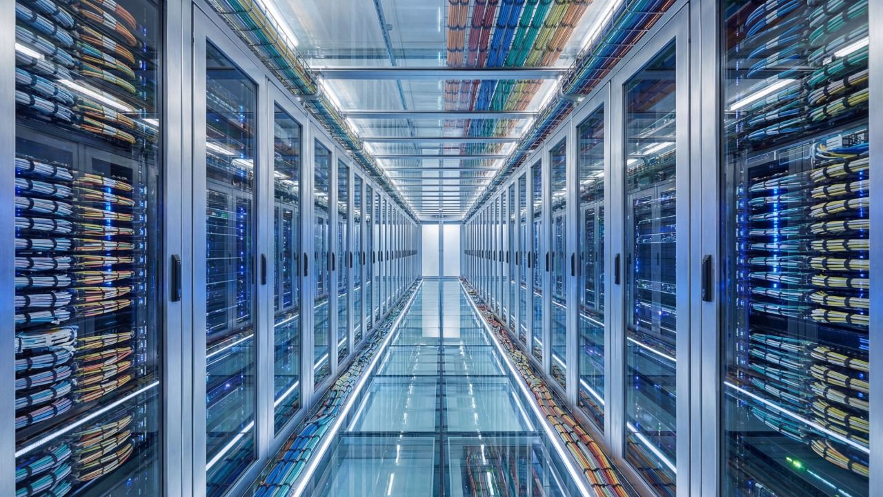 Rows of server racks and network cables inside a data center